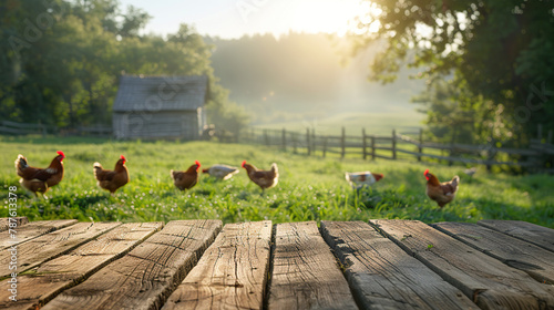 Wooden table top with blur nature farm hens or chicken, grass field background, Fresh and Relax concept.For montage product display or design key visual layout.View of copy space. photo