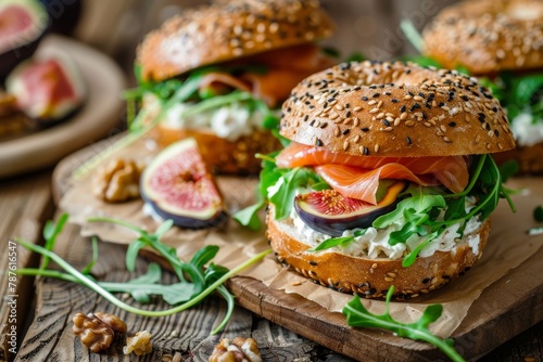 Salmon bagel with figs cress salad walnuts cream cheese and grain on rustic wood Healthy breakfast