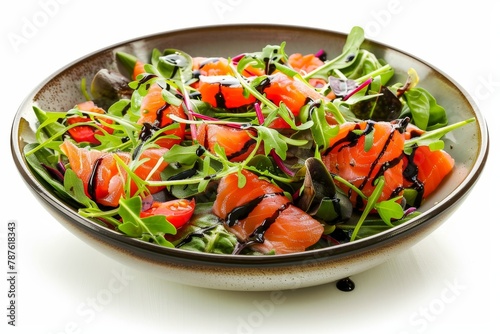 Smoked salmon salad with balsamic dressing in ceramic dish viewed from the front on a white background photo