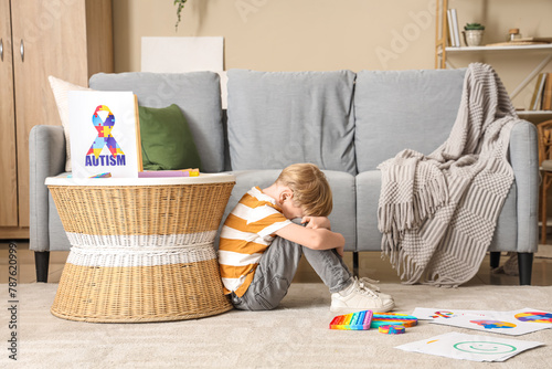 Stressed little boy sitting...