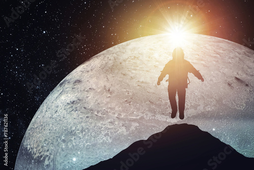 Fototapeta Naklejka Na Ścianę i Meble -  Silhouette of an astronaut levitating against the background of the planet. Elements of this image courtesy of NASA