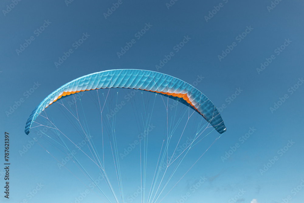 Colorful paraglider close-up against the blue sky Colorful paraglider close-up against the blue sky