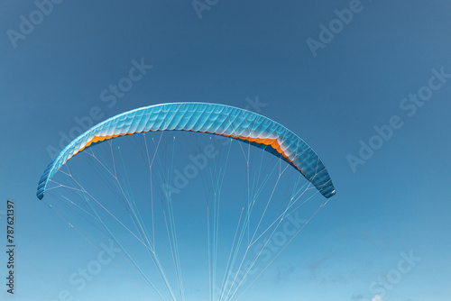 Colorful paraglider close-up against the blue sky