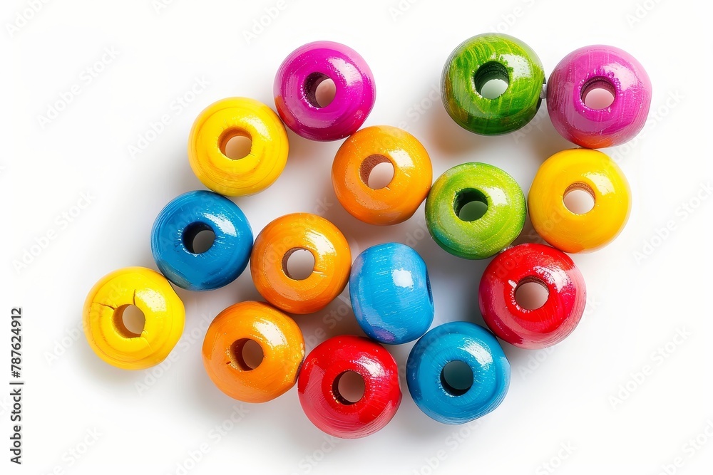 Bright colored wooden beads on a white backdrop Bright colored wooden beads on a white backdrop