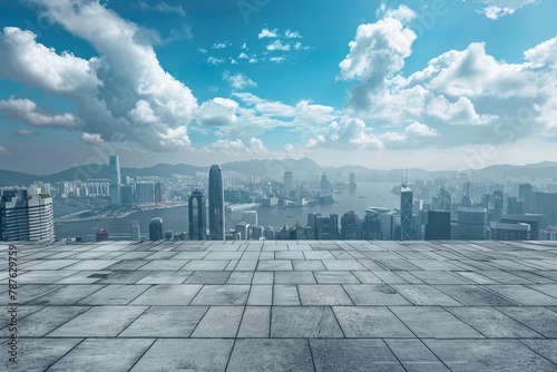 Empty concrete square floor surrounded by panoramic skyline and buildings photo