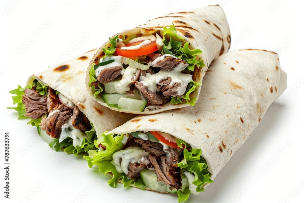 Grilled meat and salad wrap with white sauce isolated on white background Grilled meat and salad wrap with white sauce isolated on white background