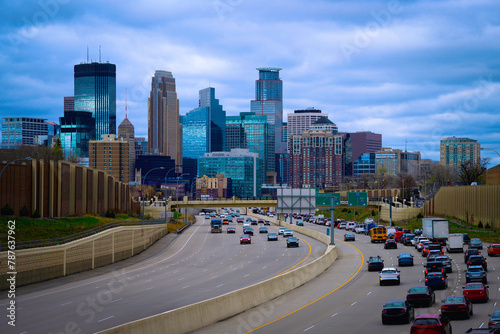 Minneapolis City Skyline and buildings in Minnesota, USA, Entering Downtown Traffic on I-94 on a stormy spring evening © Naya Na