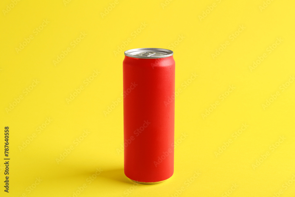 Energy drink in red can on yellow background Energy drink in red can on yellow background