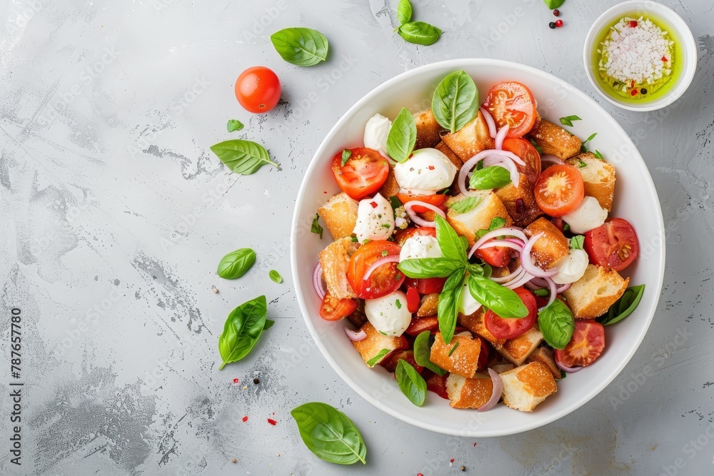 Traditional Italian Panzanella salad with tomatoes mozzarella basil onion and bread on a light grey background Classic recipe Traditional Italian Panzanella salad with tomatoes mozzarella basil onion and bread on a light grey background Classic recipe