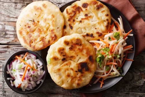 Closeup top view of Salvadoran pupusa with curtido on plate photo