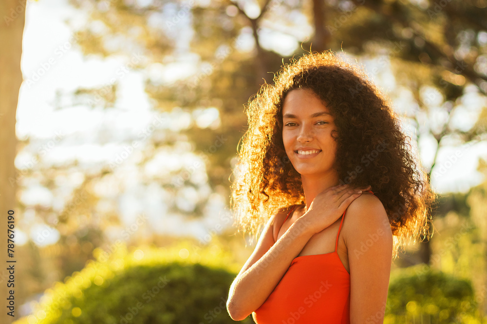 woman with curly hair portrait and the sunlight. afro woman woman with curly hair portrait and the sunlight. afro woman