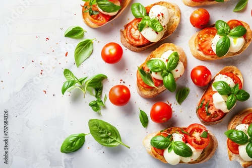 Top down view of Italian bruschetta with tomatoes mozzarella and basil on a white background Classic antipasto dish with empty space for text