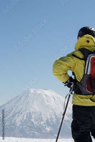 Male tourist skier looking at snow-capped Yotei mountain Niseko Hokkaido Japan