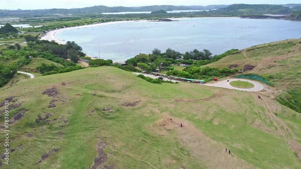 The beautiful Aerial view from the green hillside overlooking the blue sea, Bukit Merese Hill, West Nusa Tenggara, Lombok, Indonesia The beautiful Aerial view from the green hillside overlooking the blue sea, Bukit Merese Hill, West Nusa Tenggara, Lombok, Indonesia