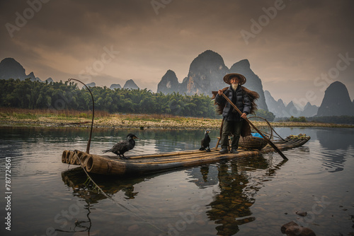 Sailing peacefully across a river  Guilin cormorant fishermen set out on river
