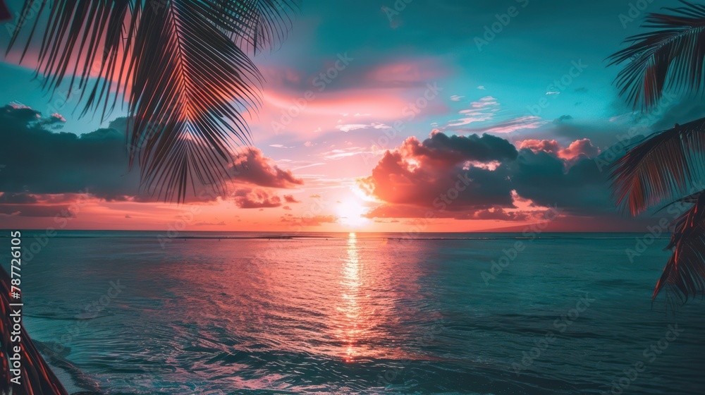 Tropical sunset view through palm leaves