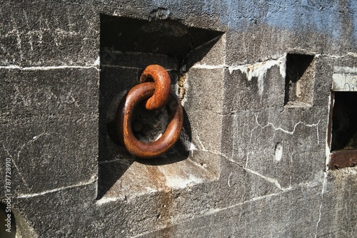 Fotografie Close up angled view of massive iron ring inset in concrete wall