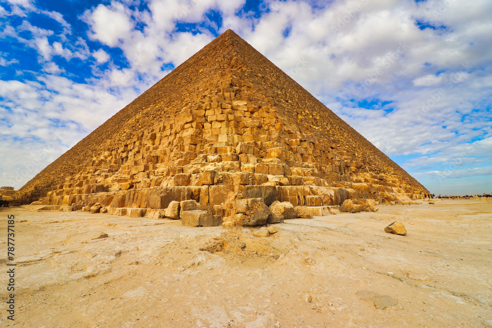 Magnificent view of the Great Pyramid of Khufu built in 2600 BC for the pharoah Khufu, ruler of the Old Kingdom's 4th dynasty on the Giza plateau on a bright day with blue skies at Cairo,Egypt
