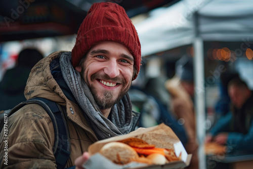 A beggar man in a shabby jacket rejoices at the food he got.