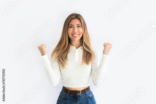 Image of happy surprised young girl isolated on white wall background making winner gesture. 