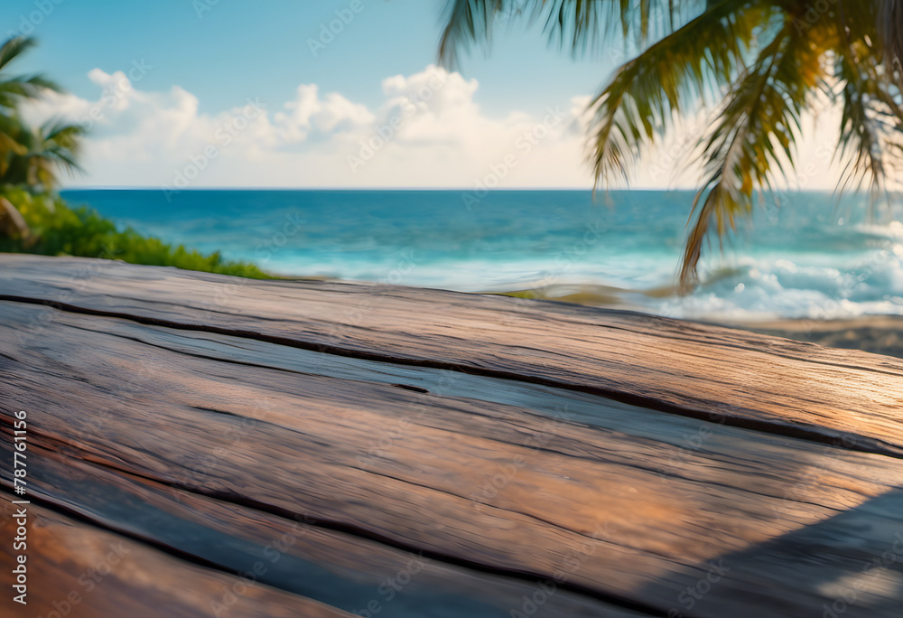 Wooden table overlooking a tropical beach with palm trees and blue ocean under a clear sky.