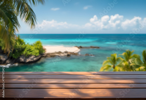 Tropical beach view from a wooden deck, featuring clear blue waters, sandy shores, and lush palm trees.