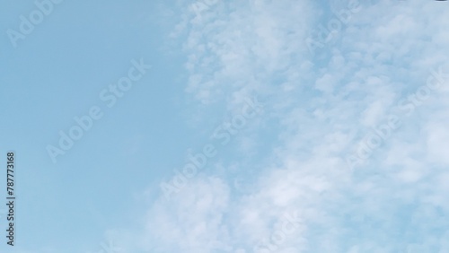 landscape photo of white clouds over a bright blue sky. blue sky background with clouds for wallpaper or decoration