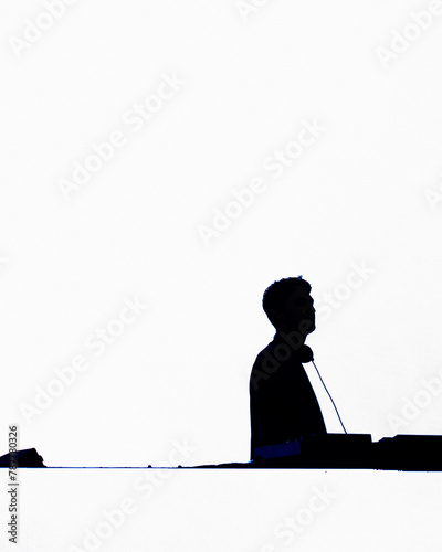 Silhoutte of a man DJing infront of a white backdrop