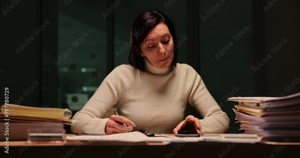 Tired teacher checks homework at work late at night Tired teacher checks homework at work late at night