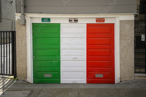 Photo of a garage door painted in the Italian flag colors of red, white and green in a historically Italian neighborhood.