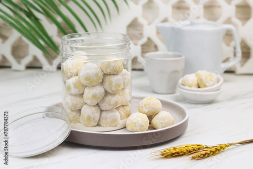 Kue putri salju or snow white cookies, popular hari raya cookies in Indonesia, baked and powdered with icing sugar. Special background for ramadan and eid mubarak. 