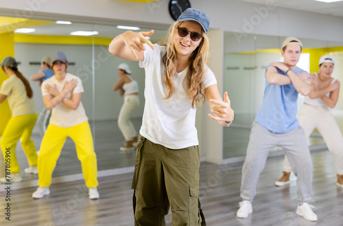 Young boys and girls performing contemporary dance in studio. photo