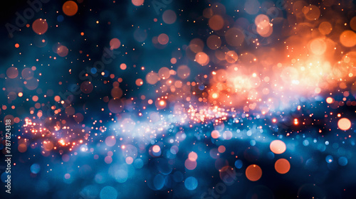 Abstract bokeh lights background with a blend of blue and orange hues, creating a dreamy and festive atmosphere.