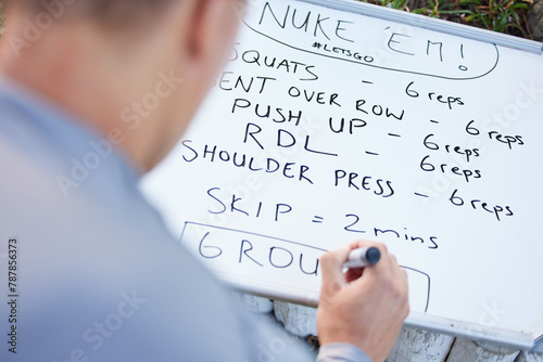 Whiteboard, outdoor and man writing, workout plan or thinking with coach or training routine. Person, outside or trainer with motivation, solution or problem solving with exercise, sports or schedule
