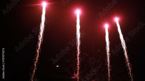 Fireworks in the sky. Beautiful array of red fireworks against a half-moon night sky with copy space with selective focus.
