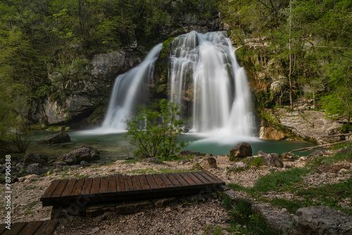 Bovec  Slovenia. Visje waterfalls. Nature trail crystal clear  turquoise water. easy trekking  nature experience  wood path. Waterfalls inside a forest  long photographic exposure  power of nature.