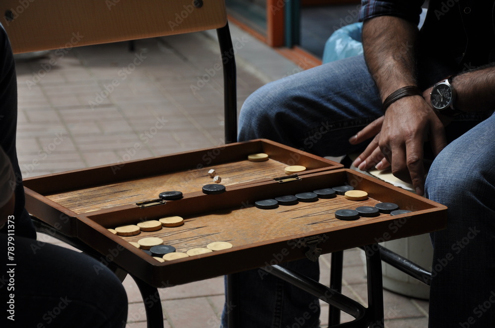 A close-up shot of two people playing backgammon A close-up shot of two people playing backgammon