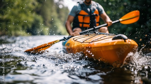 A man in a life jacket paddles an orange kayak in a river