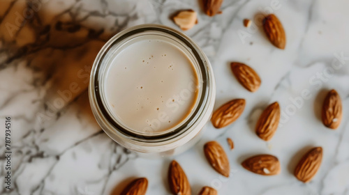 Homemade Almond Milk in Jar with Scattered Almonds