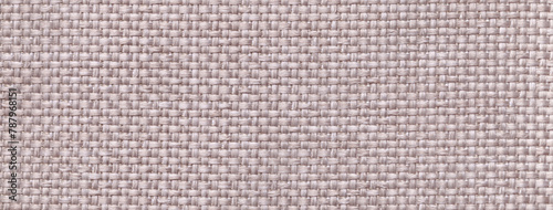 Texture of light gray background from woven textile material with wicker pattern, macro. Vintage ivory fabric