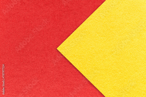 Texture of red paper background, half two colors with yellow arrow, macro. Vintage craft cardboard. © nikol85