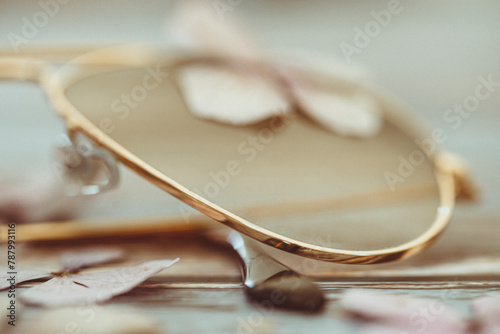 Close-up of a pair of gold rimed aviator style sunglasses photo