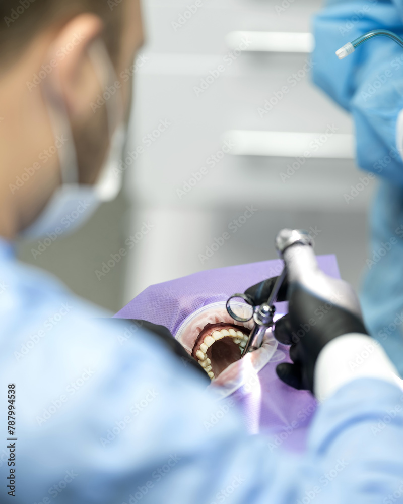 dentist injects infiltration anesthesia into patient's gums. Anesthetic