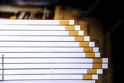 Abstract. Stack of books. Yellow stripes. Free space for text. Select focus on the edge of the book.