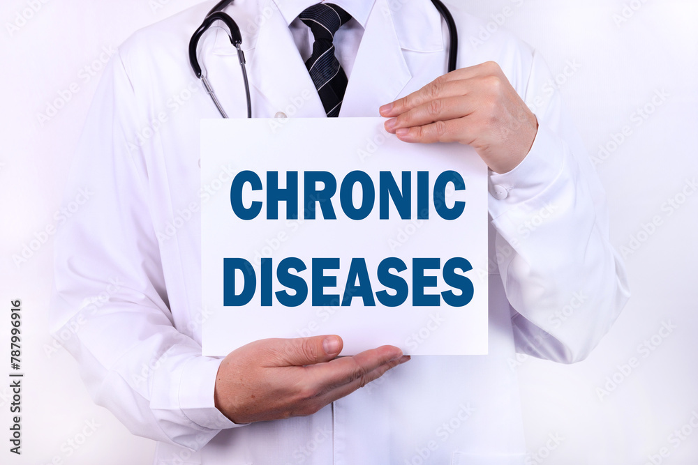 Doctor keeps a card with the name of the diagnosis - chronic disease. Medical concept. Doctor keeps a card with the name of the diagnosis - chronic disease. Medical concept.