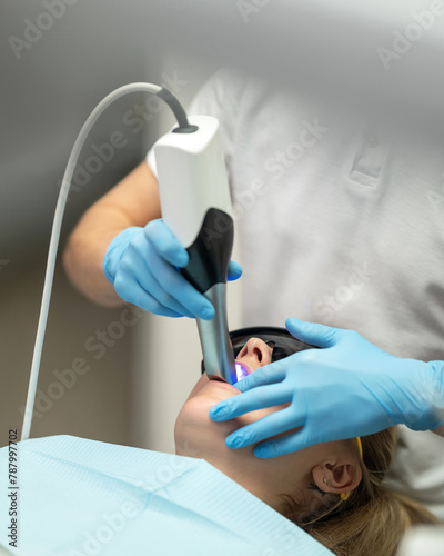 3D scanning of oral cavity. dentist performs 3D scan of oral cavity. Dentist working with intraoral scanner. 3D scanning of oral cavity to create digital impression. Top view. High quality photo