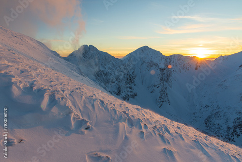 Colorful winter sunset in West Tatras Mountains. View from Volovec to the Rohace. Colorful sky and illuminated by the sun snow in foreground. © Marcin Mucharski