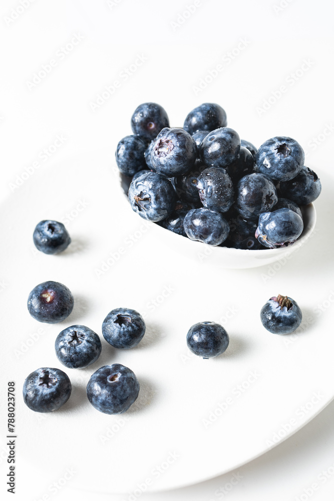 Fresh blueberries in a white bowl on a white background, with room for text Fresh blueberries in a white bowl on a white background, with room for text