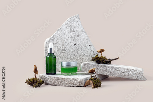 cosmetics containers on the catwalk made of stone, moss and mushrooms on a beige background