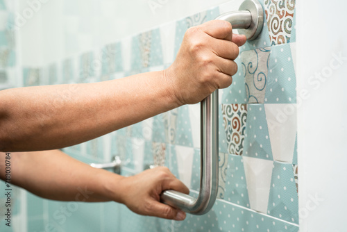 Asian elderly woman use bathroom handle security in toilet, healthy strong medical concept.